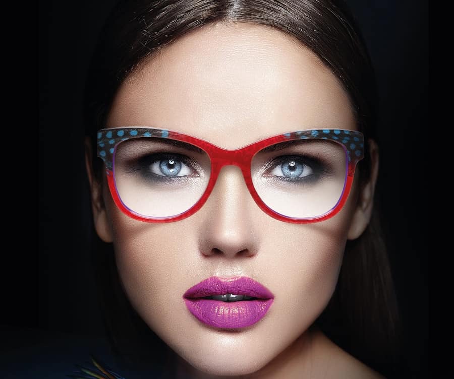 Model wearing red designer frames